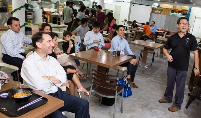 FOS lunch at Dignity Kitchen with Project Dignity CEO Koh Seng Choon (standing), relating the story of his social enterprise and the training he provides to teach the disadvantaged and disabled to operate food stalls.