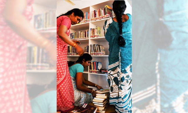 Some of the 10,000 books donated by the National Library Board being shelved at the new Youth Resource Center sponsored by Singapore Ceylon Tamils Association – a community space where young people can learn and practise English.