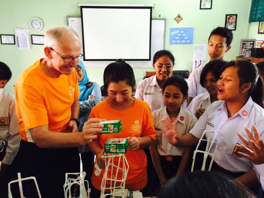 Singapore International Volunteers Richard Payne and Fiona Lee checking out the creative output of the students.
