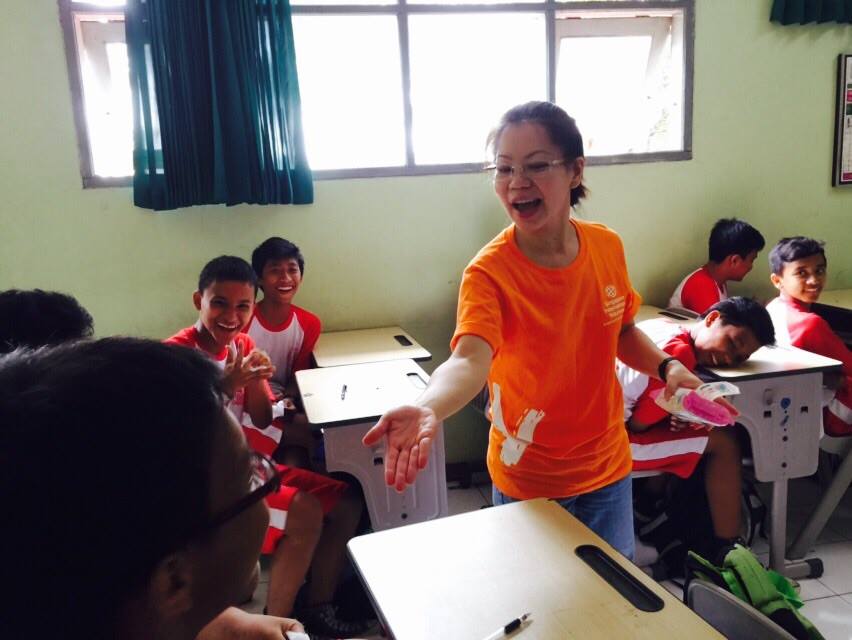 Singapore International Volunteer Winnie Teo encouraging the students to join an activity.