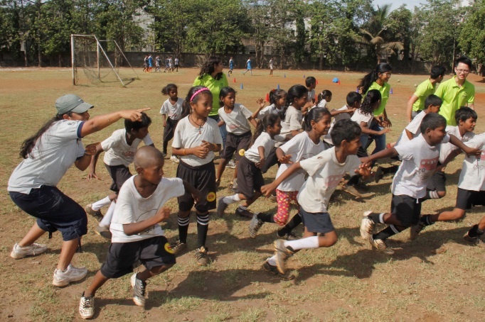 Ready, Set, Go! Our 2014 YSE participants and children from the Magic Bus community having a ball - at a game of football, organized by Magic Bus, a non-profit organization set up with the mission of ensuring India’s children and youth in need move out of poverty.