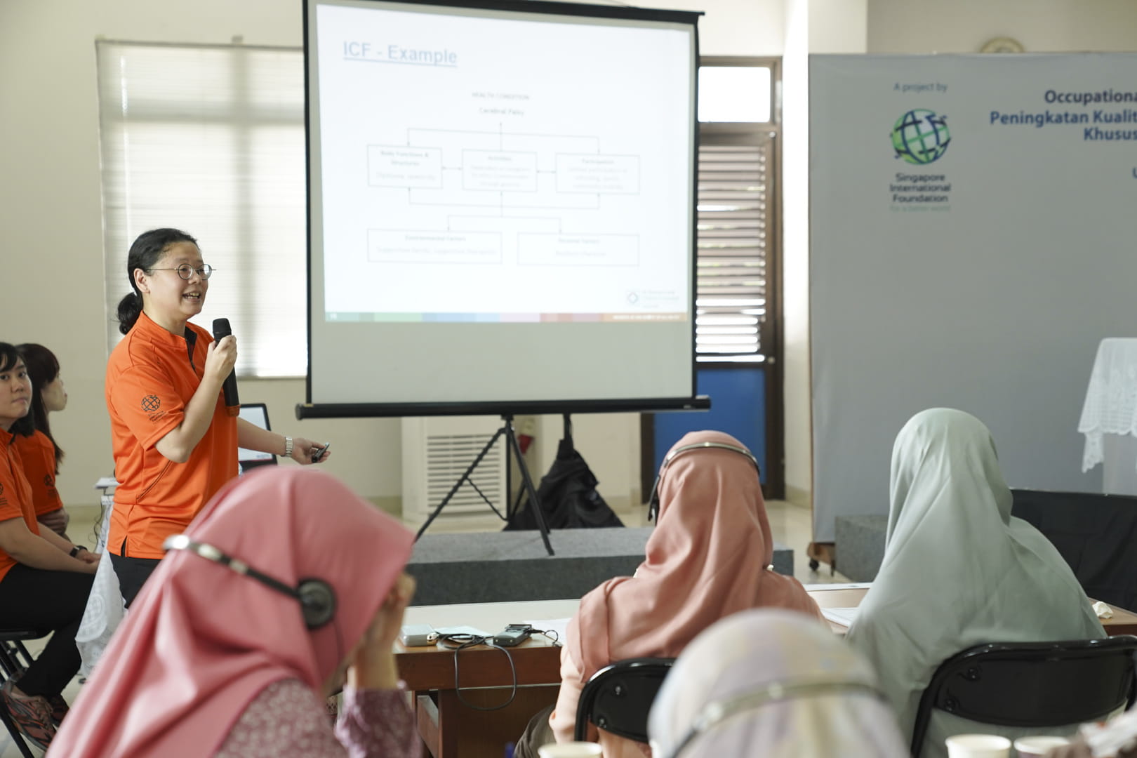 SIV Ms Jo Chen, Principal Occupational Therapist from KKH (standing) conducts the first training workshop of the four-year project with Indonesian counterparts. 