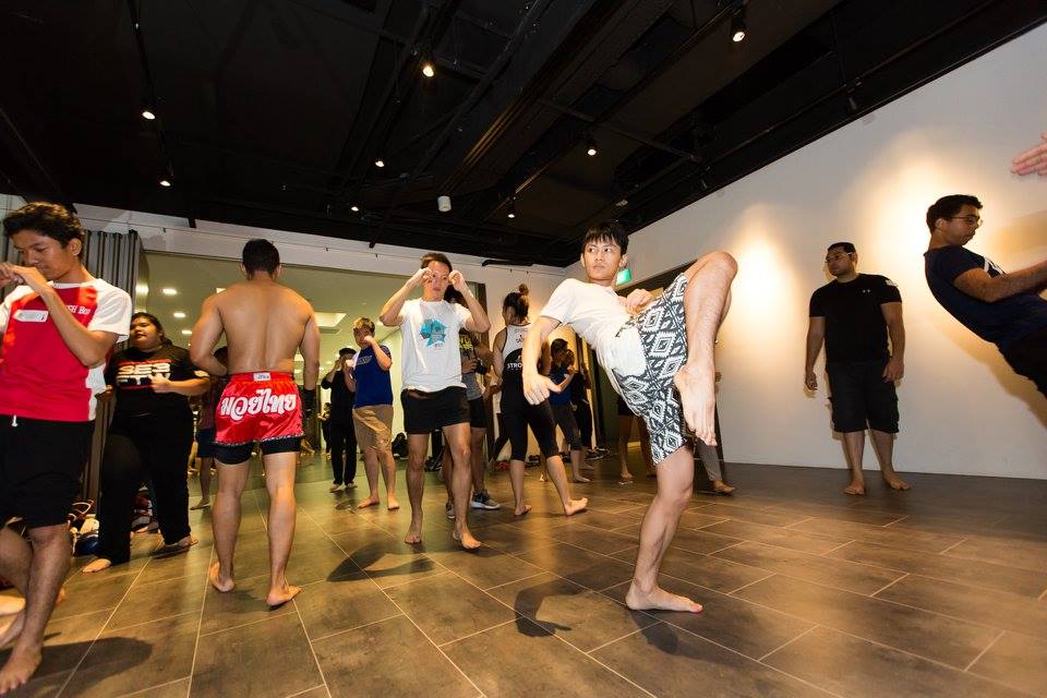 Thai and Singaporean students picking up Muay Thai moves from the volunteer trainers and students from the NTU Mixed Martial Arts Club.