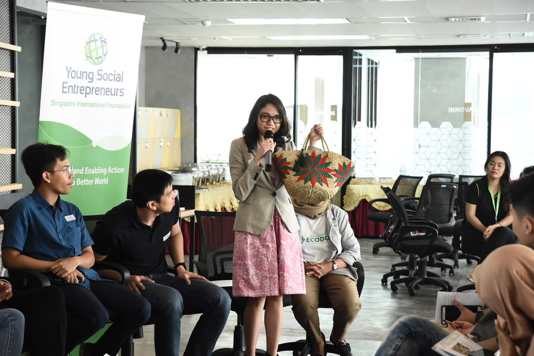 This bag is made from unused cement sacks! Vania Santoso, Co-Founder and Creative Director of heySTARTIC, showing the eco-fashion creations sold by her social enterprise, which upcycles unused materials into everyday fashions.
