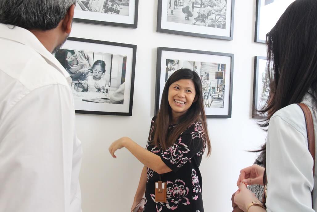 Juliet Ng, Head of Communications of Assisi Hospice sharing a photo exhibit of patients and staff. 