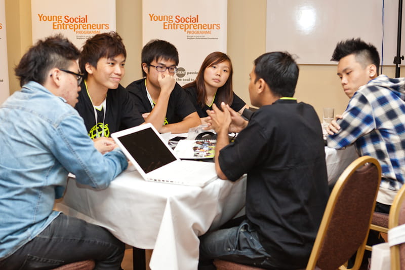 Participants discuss business ideas with their peers to refine their business plans