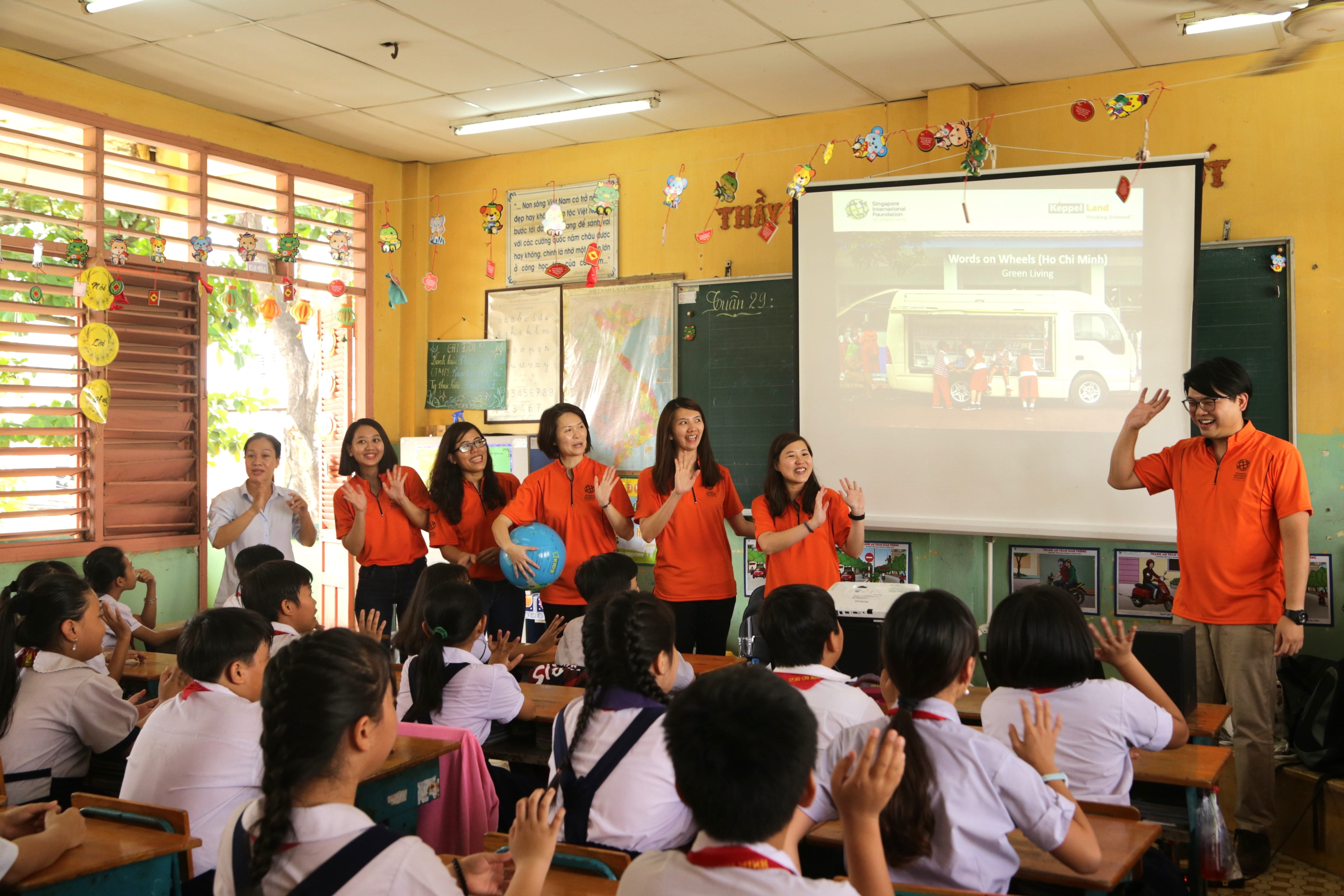 SIVs (in orange) interact with students in a classroom activity based on a curriculum designed to cultivate students’ interest in reading and learning.