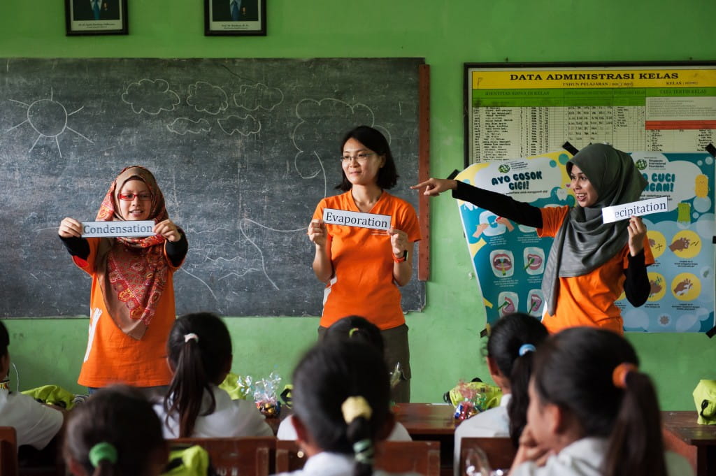 (Left to right) SIVs Far’ain Bte Jaafar, Betsy Ng and Nurul Hannah Mohd Amran carried out a water cycle learning activity for the students using cards, books and other props. The students were encouraged to be active learners and participated in the different activities.