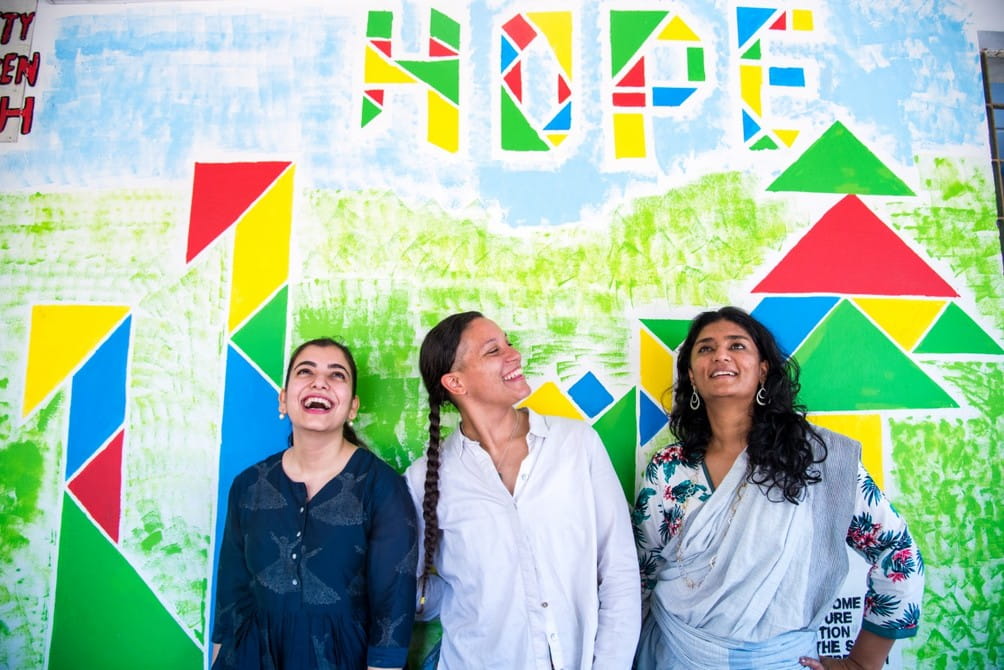 (From left) Arts for Good Fellows Jigyasa Labroo, Stephanie Turner and Kamya Ramachandran teamed up to collaborate with 100 high school students on a community mural.