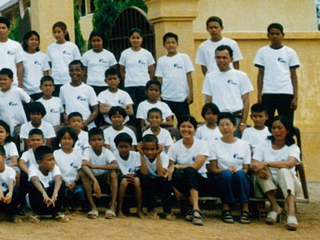 Elsie (first row, second from right) discovered her “skill sets were a perfect fit” for the task at hand, using drama, songs, games and finger plays in her lessons.