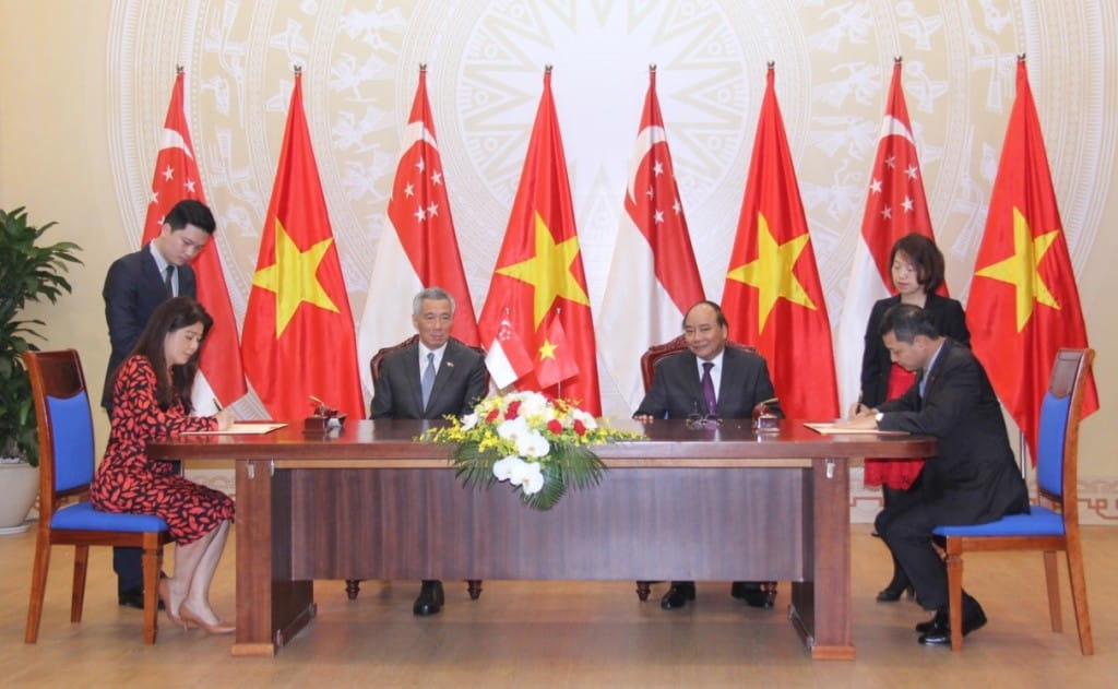 Ms Jean Tan, SIF Executive Director (seated, left) and Mr Vu Viet Ngoan, Chairman, VSFA (seated, right) co-sign a Memorandum of Understanding witnessed by the Prime Minister of Singapore Mr Lee Hsien Loong (seated, second from left) and his Vietnamese counterpart Prime Minister Nguyen Xuan Phuc (seated, second from right), in conjunction with Mr Lee’s official four-day visit to Vietnam in March 2017.
