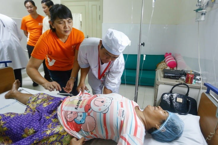 SIF’s Orthopaedic & Rehabilitation Specialist Training Project: SIV A/Prof Celia Tan training physiotherapist trainee Mr Sokhom from Calmette Hospital in techniques to enable the patient to recover during post-surgery.