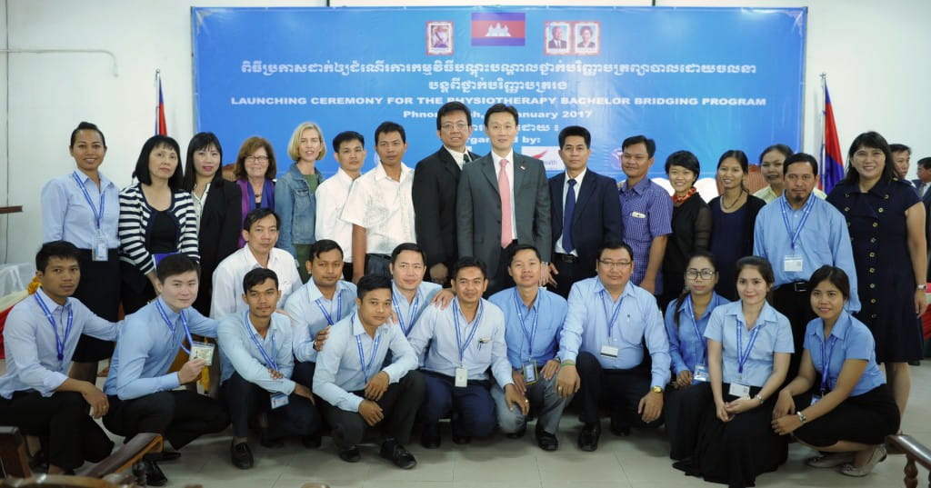 The pioneer batch of students in the Physiotherapy Bachelor Bridging Programme (in light blue uniforms) takes one for the album with His Excellency Mr Michael Tan, Singapore’s Ambassador to the Kingdom of Cambodia (top row, centre), Singapore International Volunteers and representatives from the Singapore International Foundation, Singapore Health Services and University of Health Sciences, Cambodia.