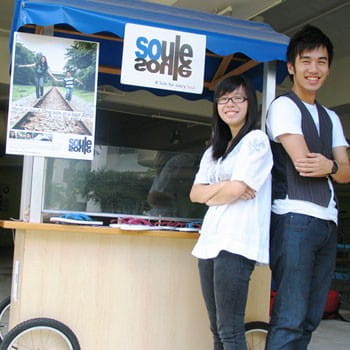 Justine (right), along with co-founder Lim Jing Ying at the Ngee Ann Polytechnic pushcart where they first started selling their flip flops.