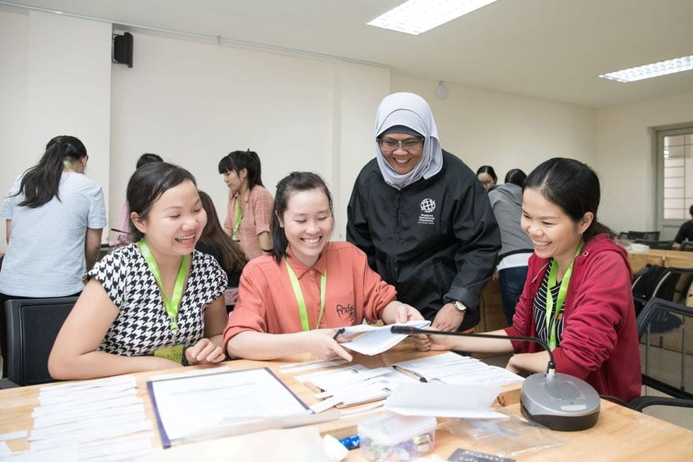 Singapore International Volunteer Ms Rozila Binte Mahmud (black jacket), Lead Teacher, Rainbow Centre Yishun Park, engaging with Vietnamese teacher trainees during a workshop on teaching children with autism spectrum disorder.